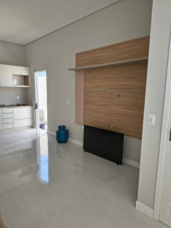 a living room with a flat screen tv on a wall at Casa Jardim dourado in Porto Belo