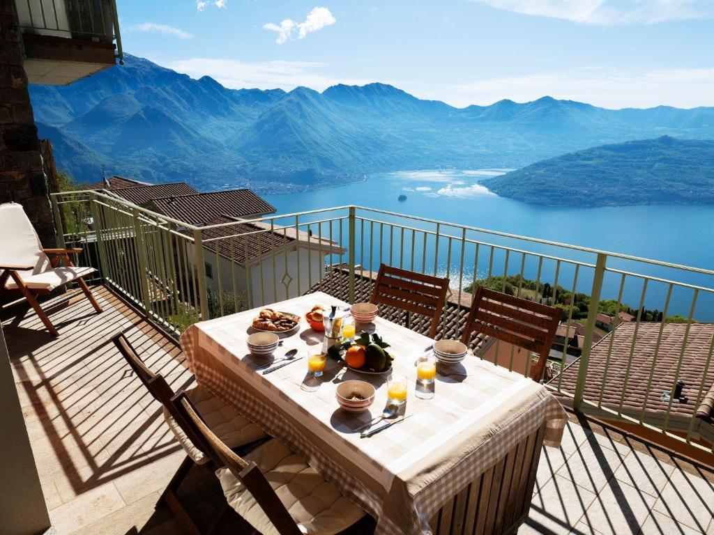 a table on a balcony with a view of the mountains at Apartment 'Cezanne by Interhome in Parzanica