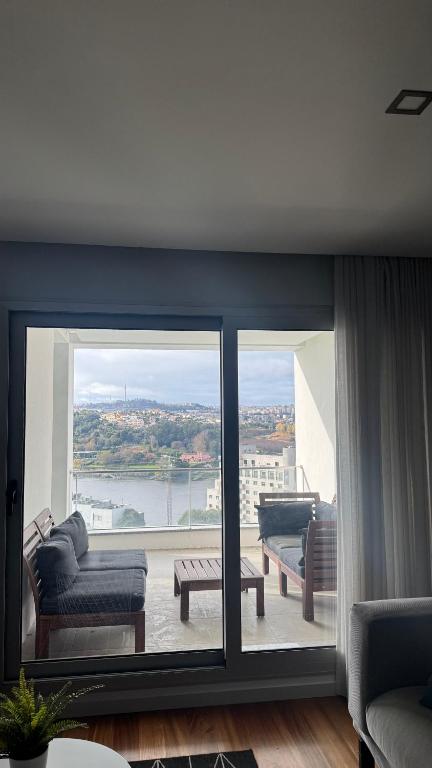 a living room with couches and a view of the water at Casa Douro in Valbom