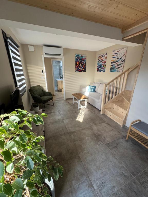 a living room with a couch and a table at Lodges des Pontons - Cap Sud - vue mer in Saint-Côme-de-Fresné