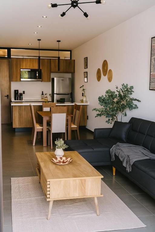 a living room with a couch and a table at Stylish Condo Steps to Beach & Malecón in Mazatlán