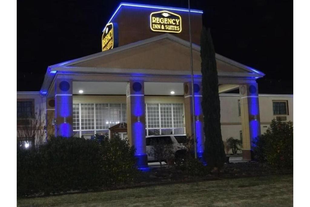 a house with blue lights on the front of it at Regency Inn & Suites Houston East I 10 in Houston