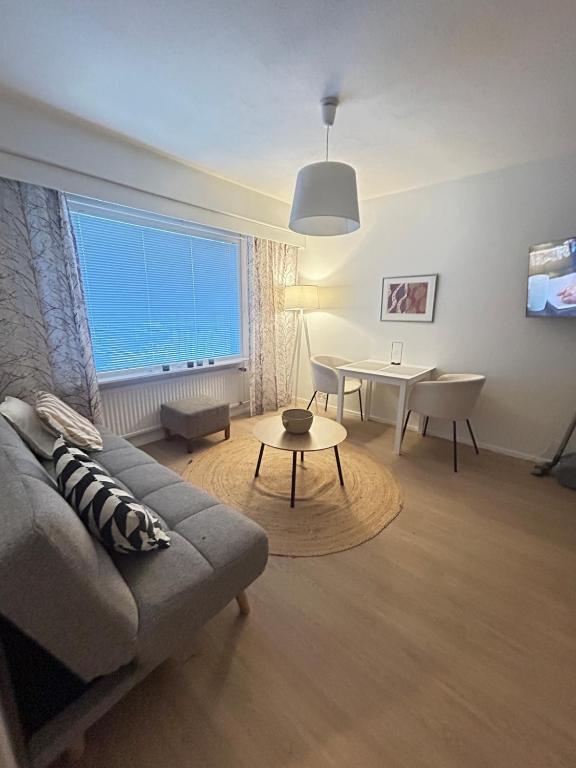 a living room with a couch and a table at Lomayksiö Vääksy 34m2 in Vääksy