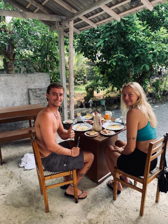 a man and a woman sitting at a table at Costal View-Ahangama in Ahangama