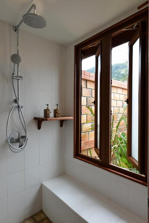 a bathroom with a shower and a window at PingChan Koh Phangan Beachfront Resort in Thong Nai Pan Yai