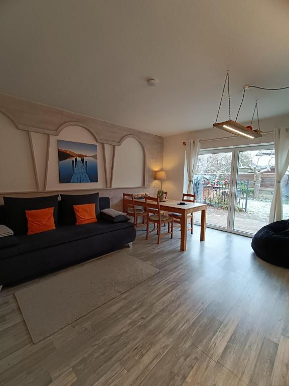 a living room with a couch and a table at Stylish & Spacious Apartment with Patio in Stams