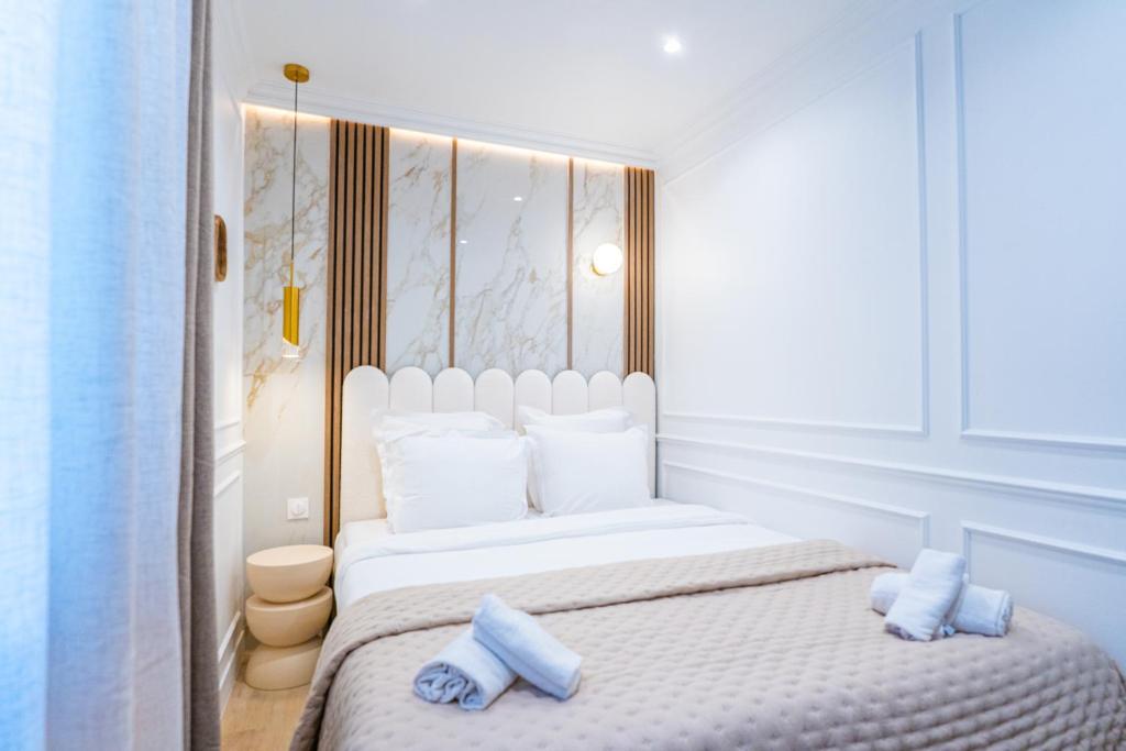 a bedroom with a white bed with blue towels on it at Garbo hotel in Paris