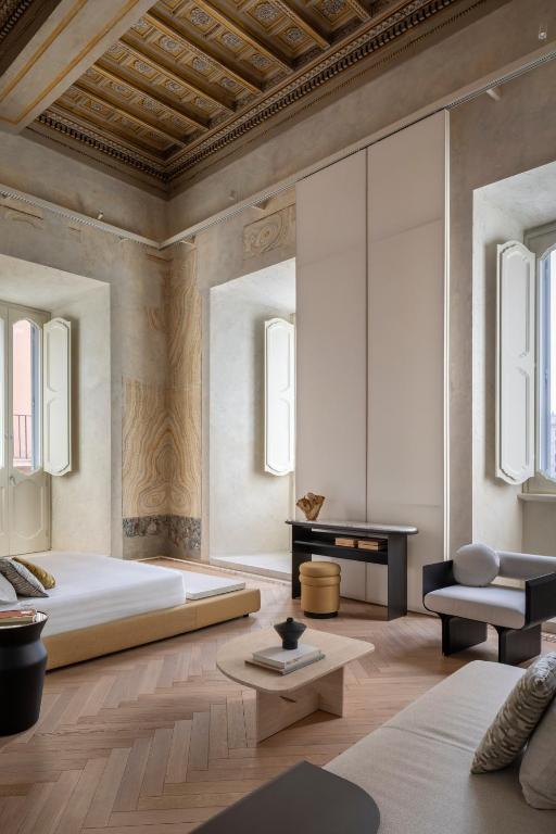 a bedroom with a large bed and a table at Hotel Trame in Rome