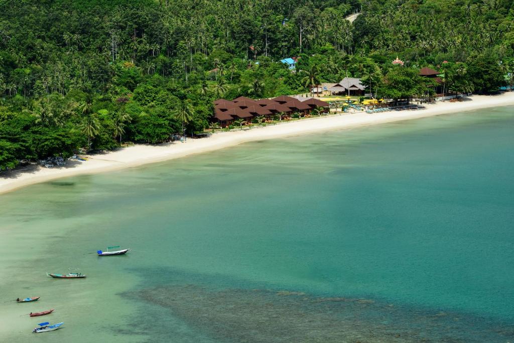 two boats in the water next to a beach at PingChan Koh Phangan Beachfront Resort in Thong Nai Pan Yai