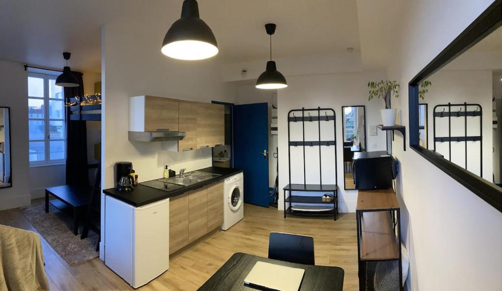 a kitchen with a sink and a counter top at Au coeur de la Roche in La Roche-sur-Yon