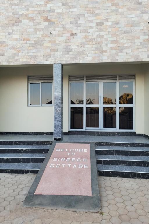 a sign in front of a building that says lift future emergency corridor at Simbego Cottages Lira in Lira