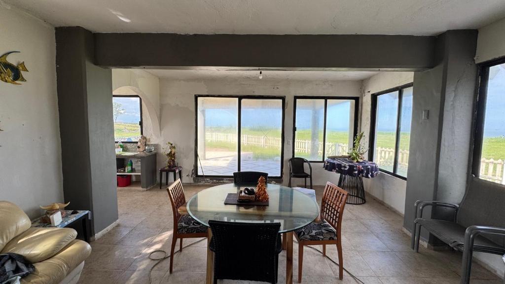 a living room with a table and chairs at Beach chalet with Private Pool in Heroica Alvarado