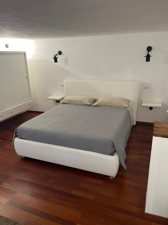 a bedroom with a white bed in a room at Rent Room Sardegna in Porto Torres