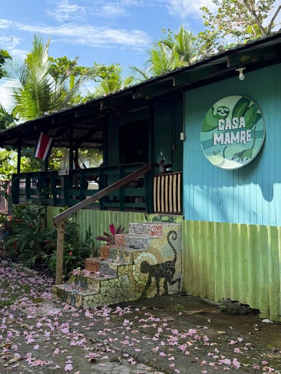 a building with a sign that reads pasta mananca at Casa Mamré in Cahuita