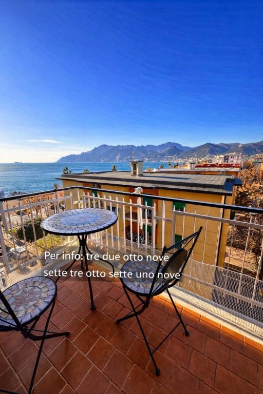 a patio with a table and chairs on a balcony at Sul Mare Apartment - Seafront with Sea View in Salerno