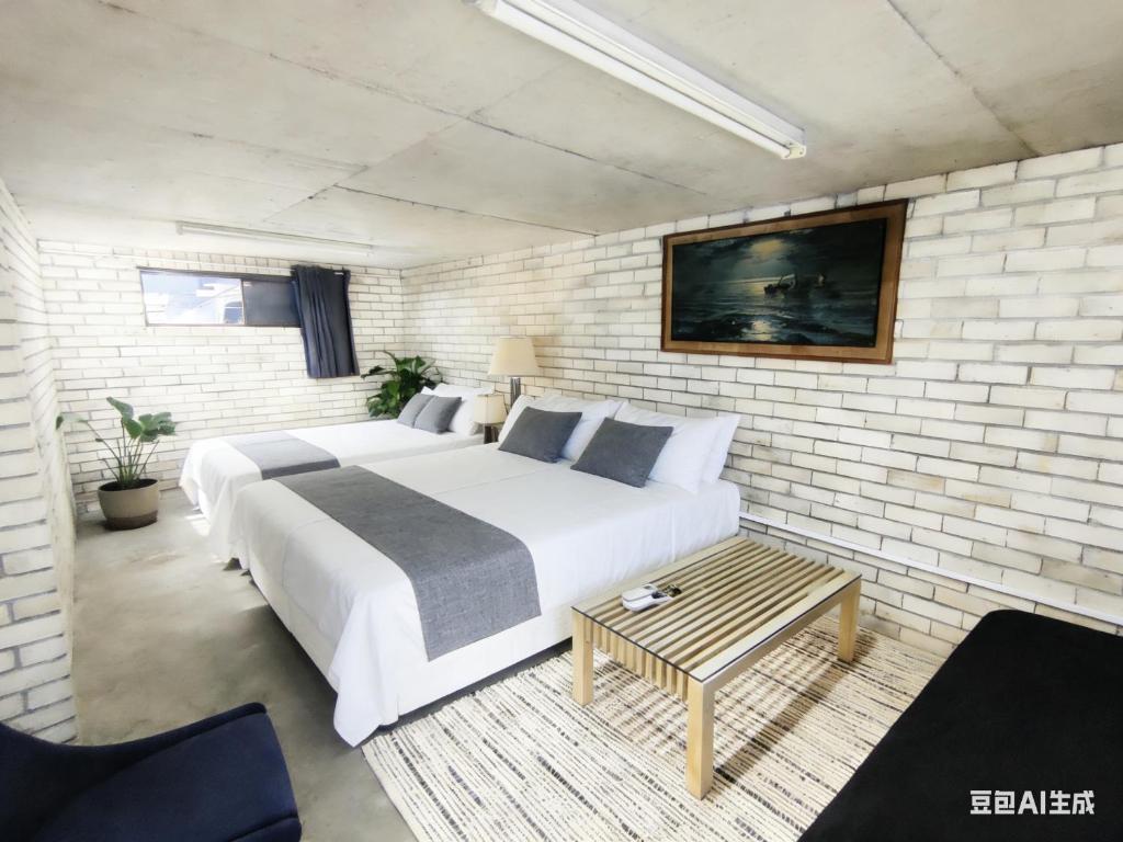 a bedroom with a large bed and a brick wall at Burwood central home in Sydney