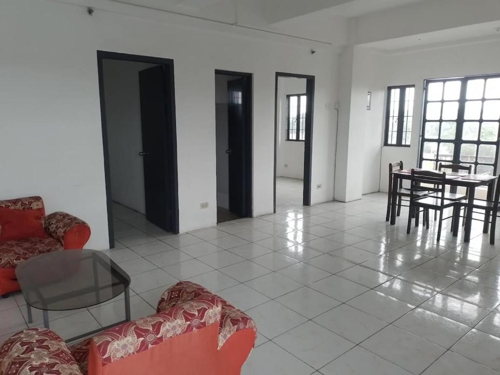a living room with chairs and a table and a table and chairs at Condo Unit 5A in Batangas City in Batangas City