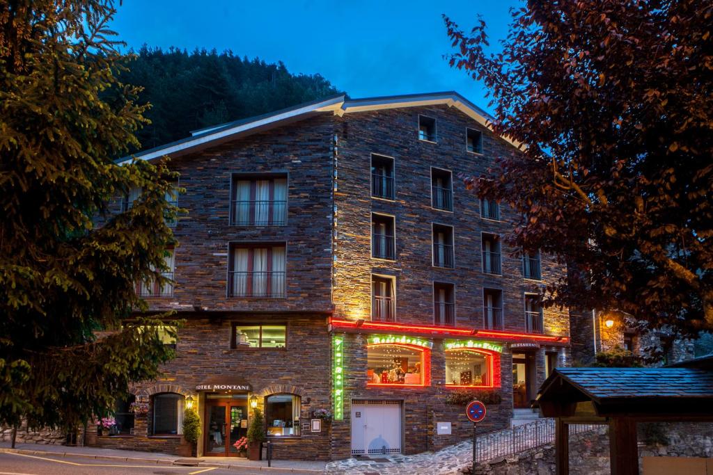 a large brick building with christmas lights on it at Hotel Montané in Arinsal