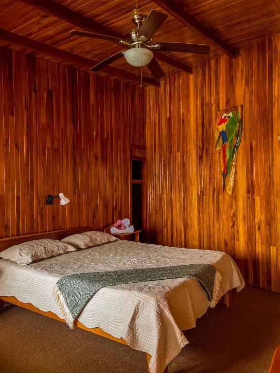a bedroom with a bed and a kite on the wall at Hotel El Atardecer in Monteverde Costa Rica