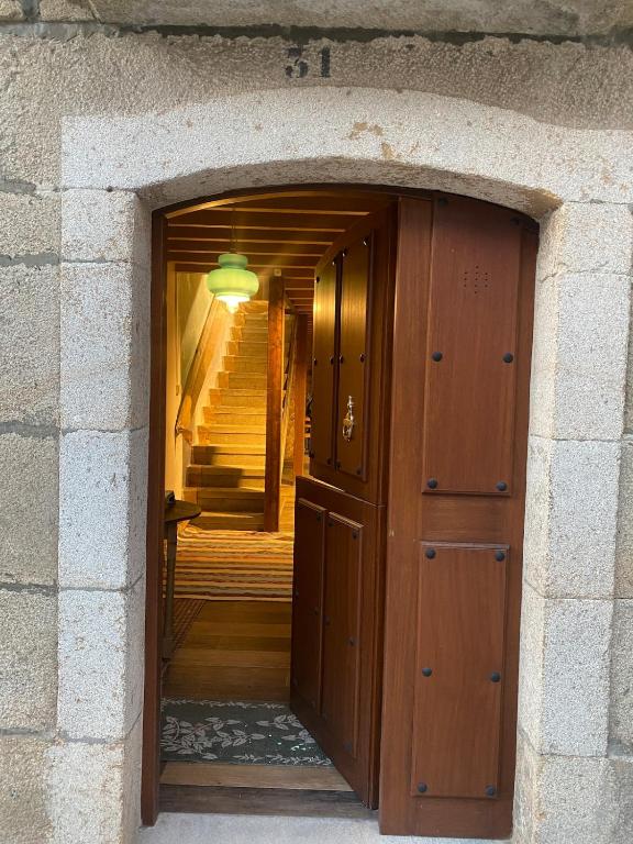 a door into a room with a staircase in the background at Casa Pueblo Anibal in Fermoselle