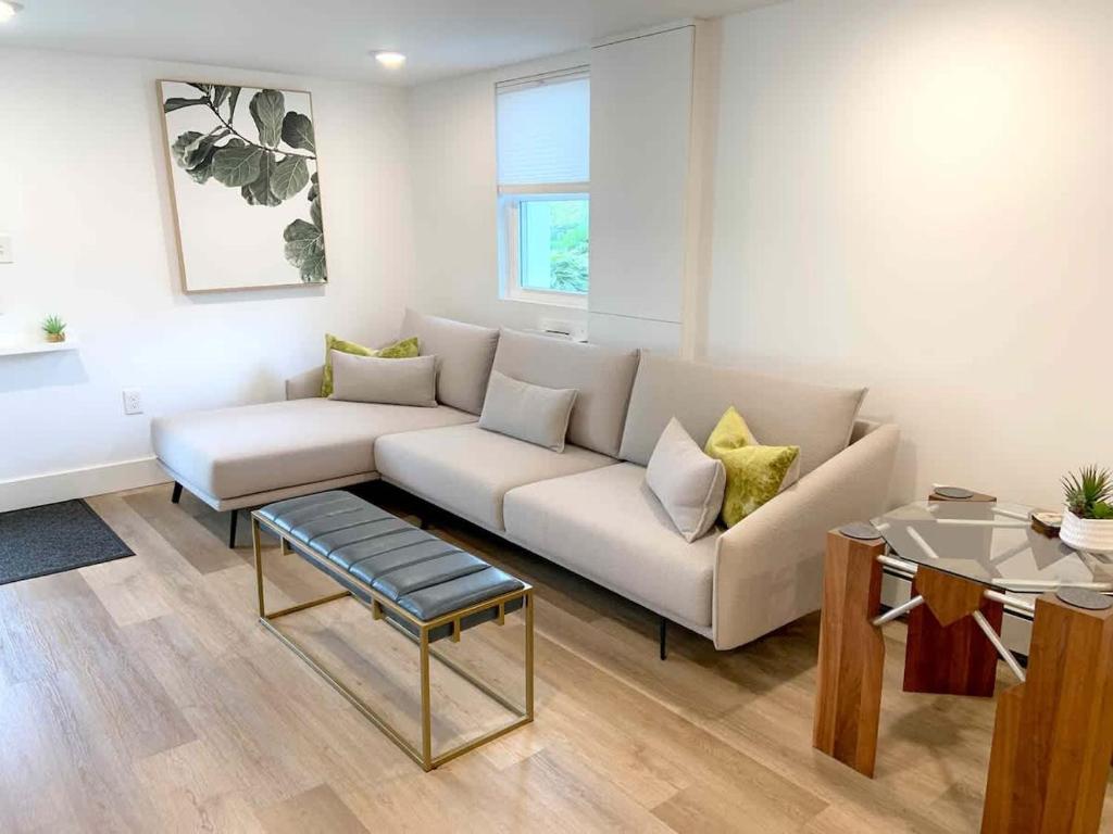 a living room with a white couch and a table at Fresh Modern Garden Level Kittery Studio in Kittery