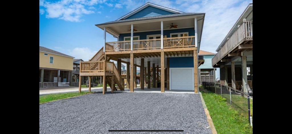 a large house with a balcony on a street at Stunning Beach Front House in Crystal Beach