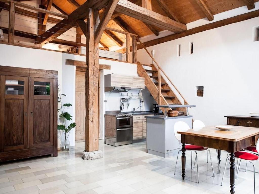 a kitchen with a wooden table and a wooden staircase at Apartment Studio by Interhome in Schernfeld