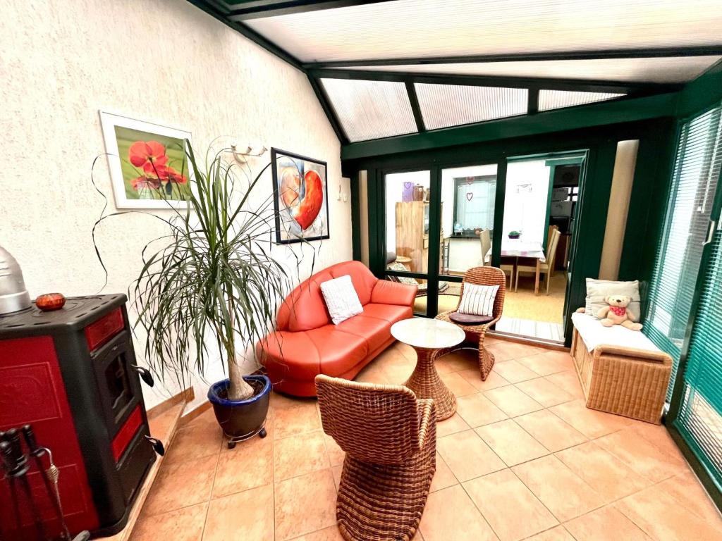 a living room with a couch and a tv at Apartment Spitzwegerich by Interhome in Kappe