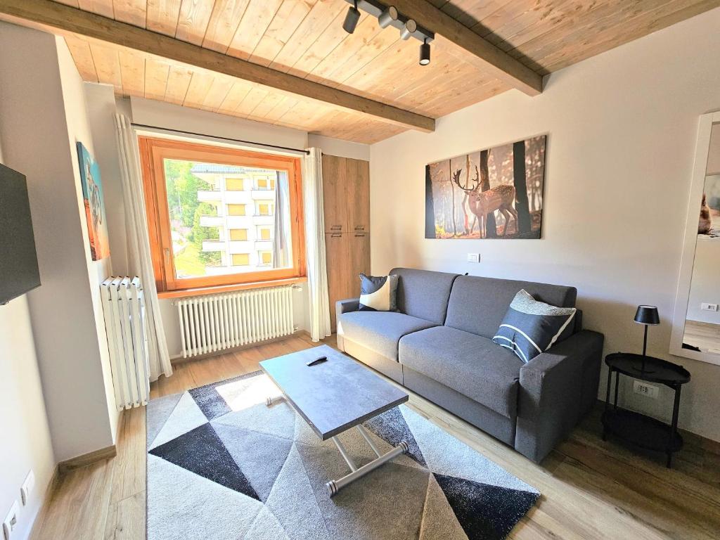 a living room with a couch and a table at Moda Apartments 69 in Sestriere