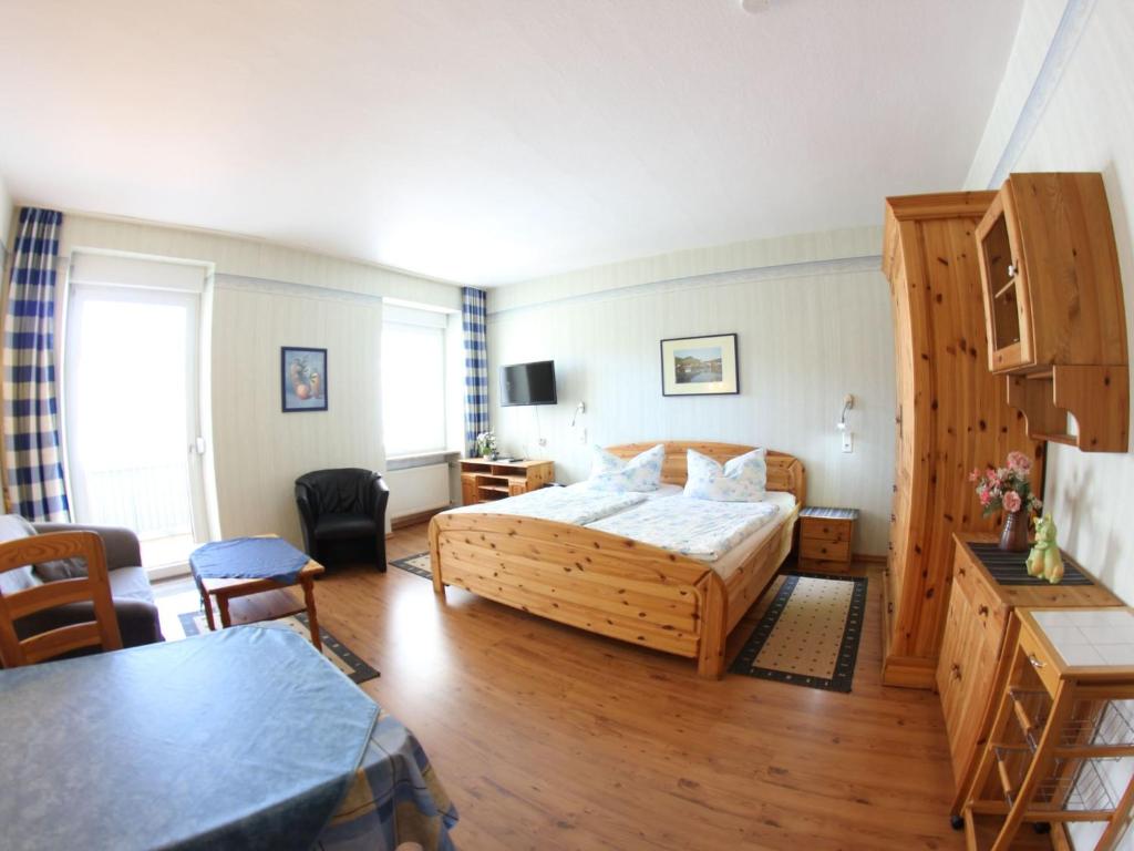 a hotel room with a bed and a table at Apartment Haus Budinger by Interhome in Alf