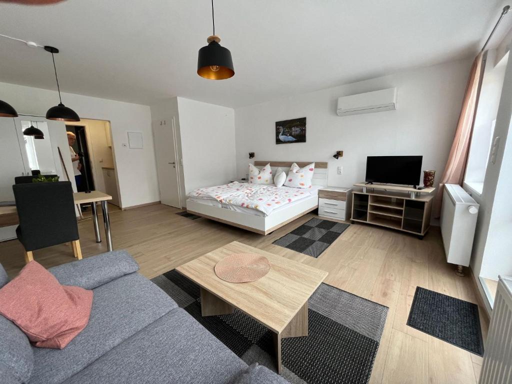 a living room with a bed and a couch at Apartment Haus Budinger by Interhome in Alf