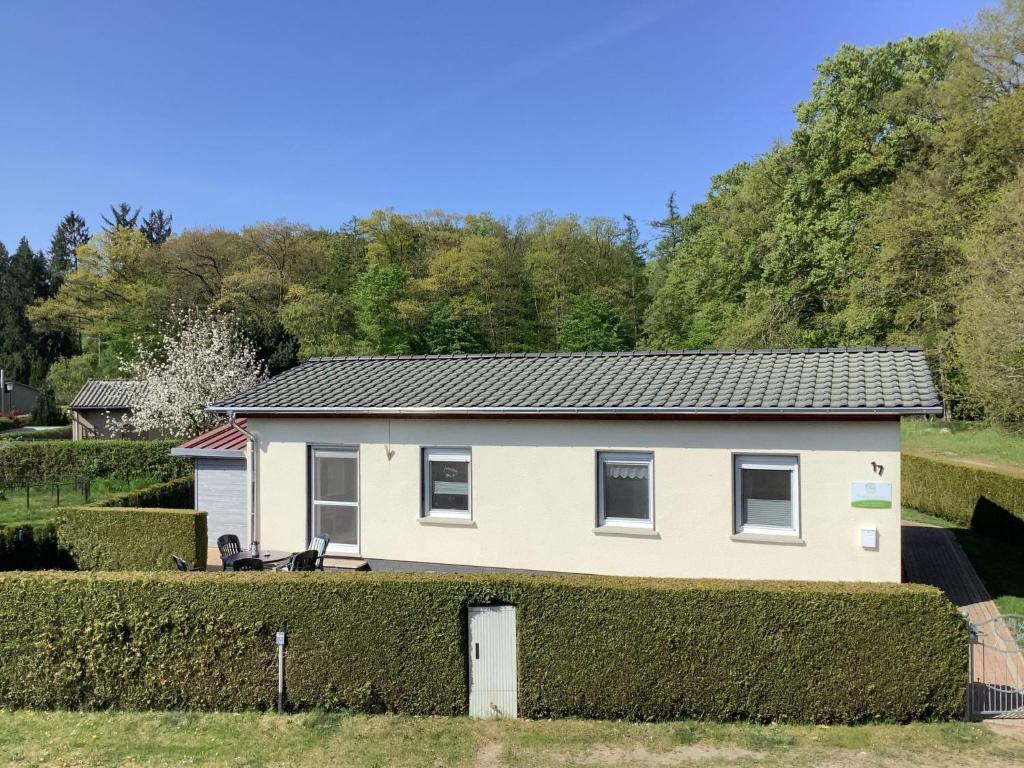 a white house with a hedge at Holiday Home Klosterwald by Interhome in Dargun