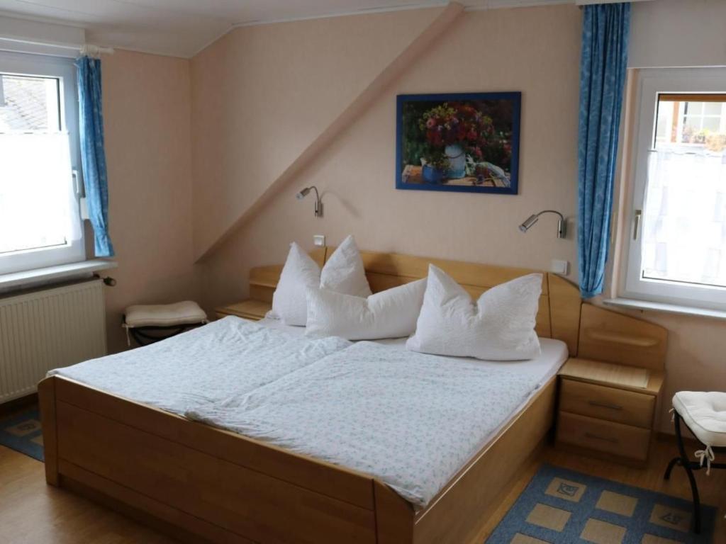 a bedroom with a bed with white sheets and pillows at Apartment Haus Budinger by Interhome in Alf