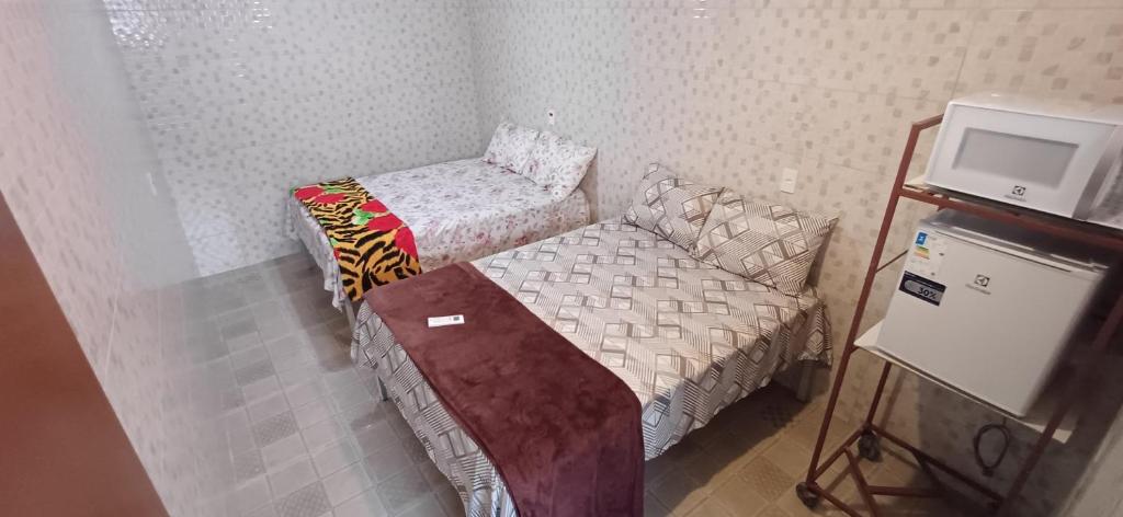 a small room with a bed and a couch at "Taberna dos Castilho" in Bertioga
