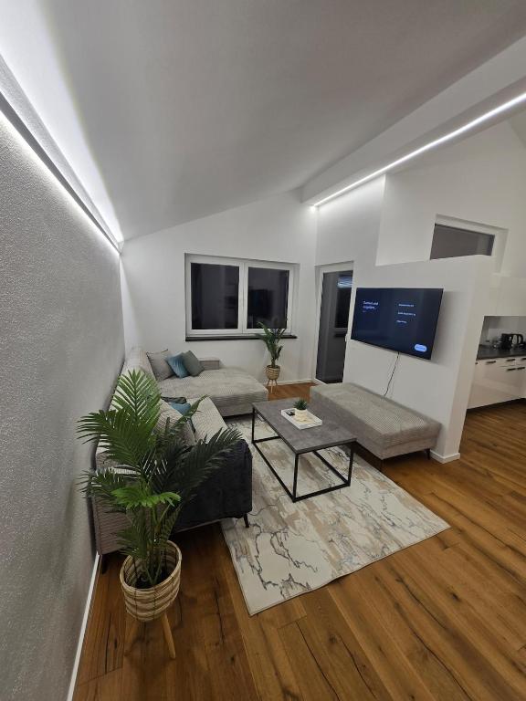 a living room with a couch and a table at Stylische Ferienwohnung 2 in Salzburg