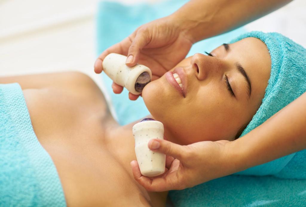 a woman getting a massage from a therapist at PortoBay Falesia in Albufeira