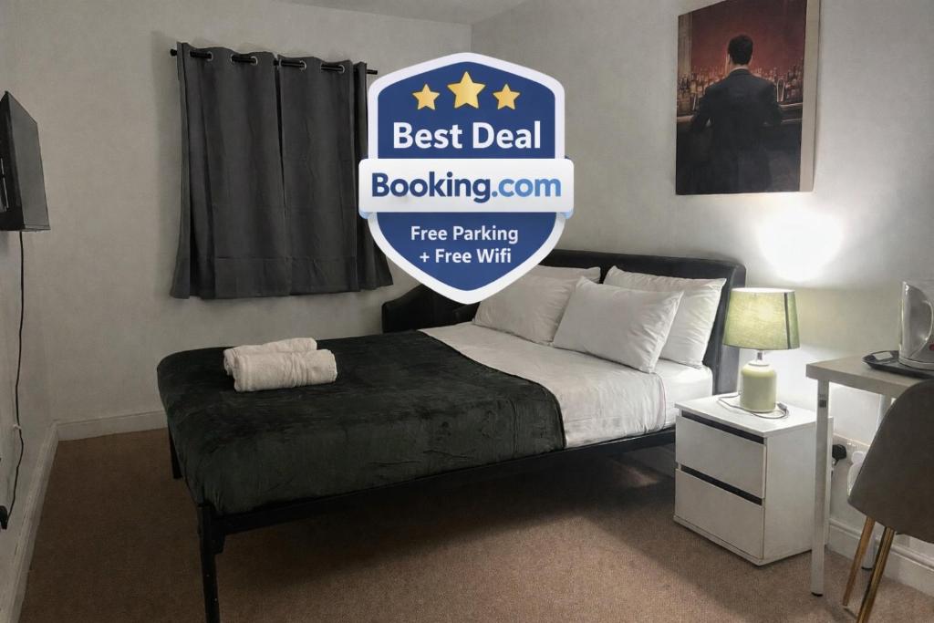a bed with a sign that says best deal boxingam free parking free wifi at King Street Hotel in Blackburn