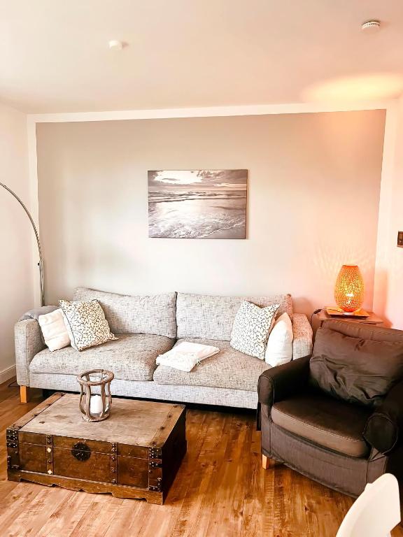 a living room with a couch and a coffee table at Haus Clara in Hörnum