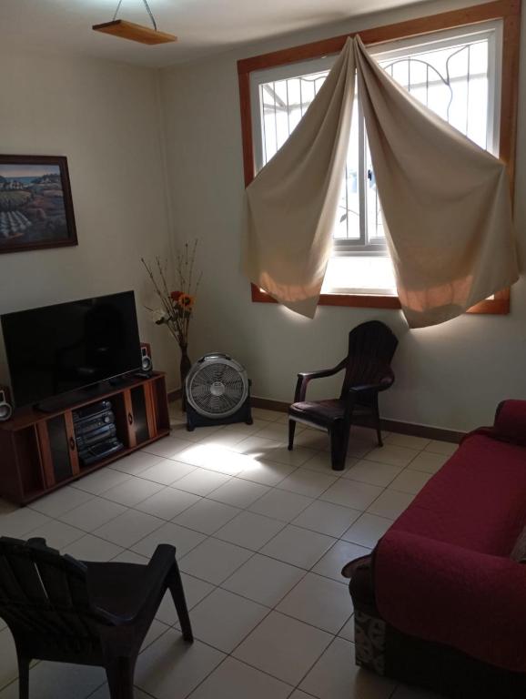 a living room with a couch and a window at Casa Miranda - Retalhuleu in Retalhuleu