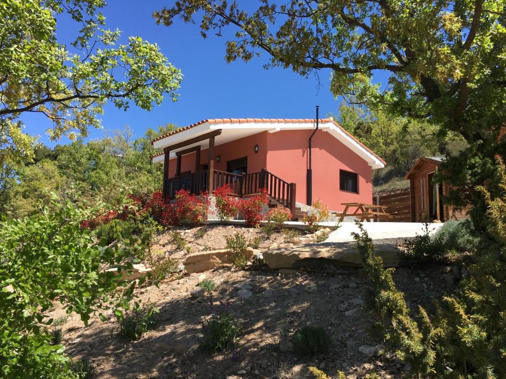 a house on top of a hill with trees at La Caseta del Montsec in Àger