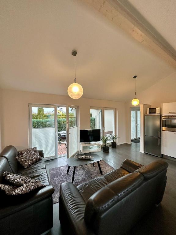 a living room with a couch and a table at Ferienhaus Schlossblick - ABC236 in Zierow