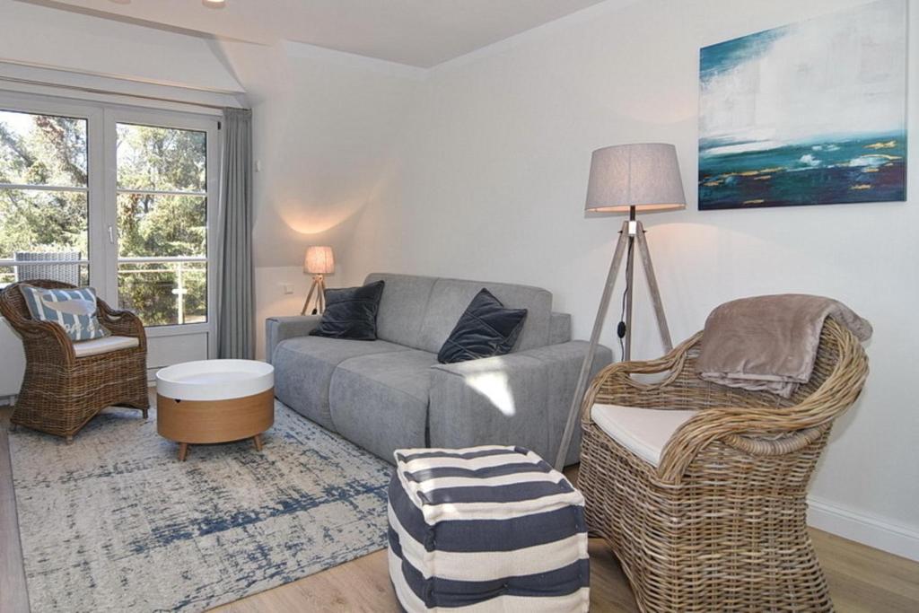 a living room with a couch and a chair at Luv & Lee, Whg 10 in Westerland