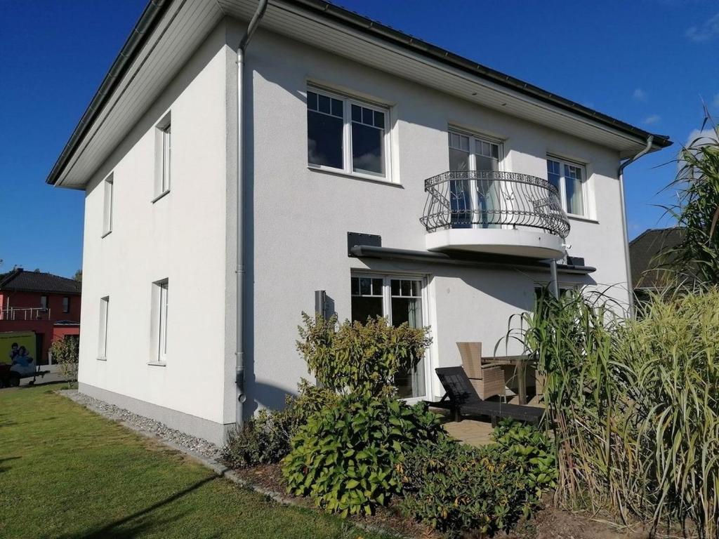 a white house with a balcony at Stadthaus Lübsche Burg - ABC326 in Wismar