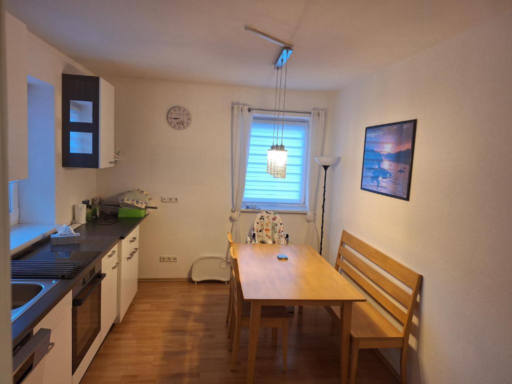 a kitchen with a wooden table and a dining room at Familienwohnung Emprechting in Emprechting