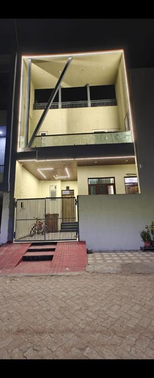 a building with a balcony with a staircase on it at Full villa welcome for you 4bhk available in Jaipur