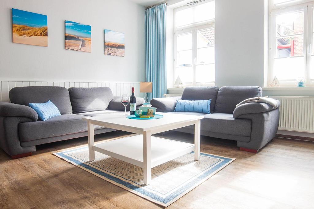 a living room with a couch and a table at Amoy - Werftstraße 2 in Heiligenhafen