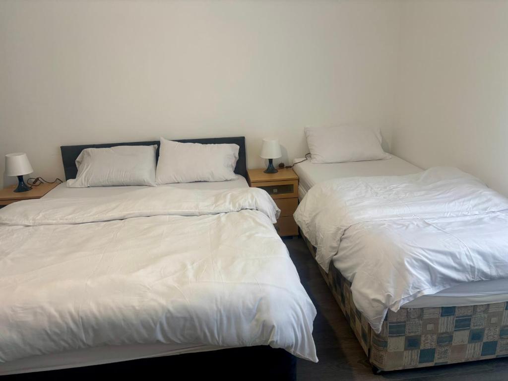 two beds sitting next to each other in a room at Serene Studio in Dudley in Dudley