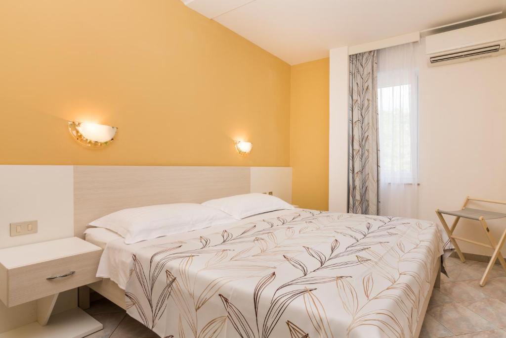 Postel nebo postele na pokoji v ubytování Apartments Amfora Plava Laguna