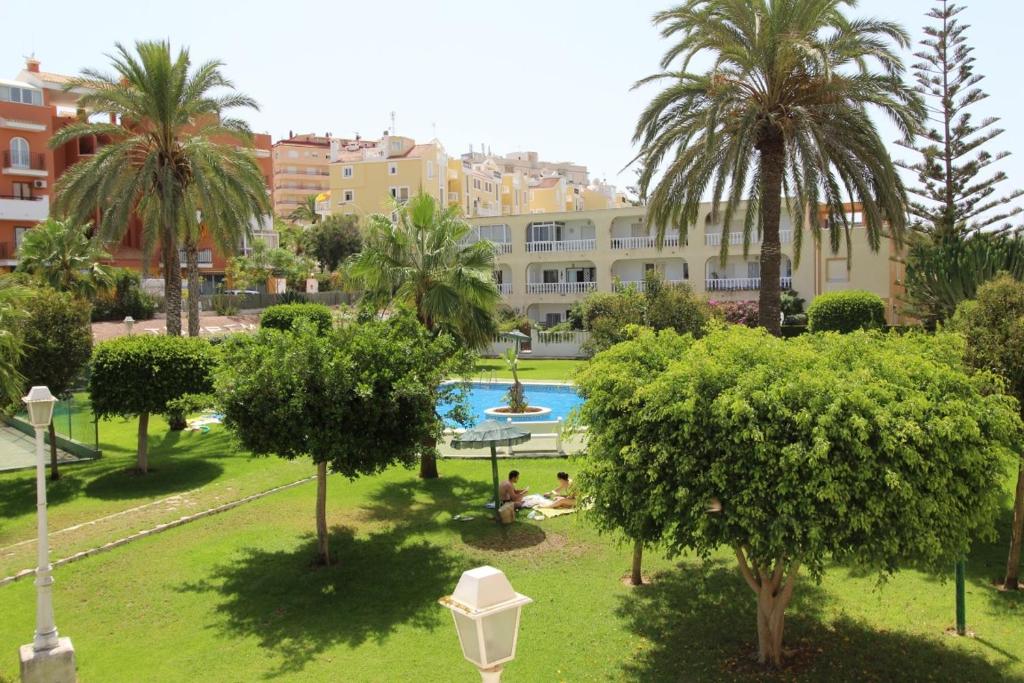 a view of a park with a swimming pool and palm trees at Bungalow Torremata Ref 3778 in La Mata