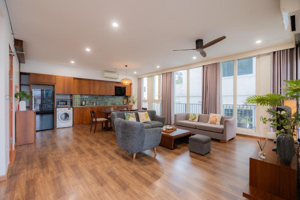 a living room with a couch and a table at XÔI Sakamoto 2 Suites Kim Ma in Hanoi